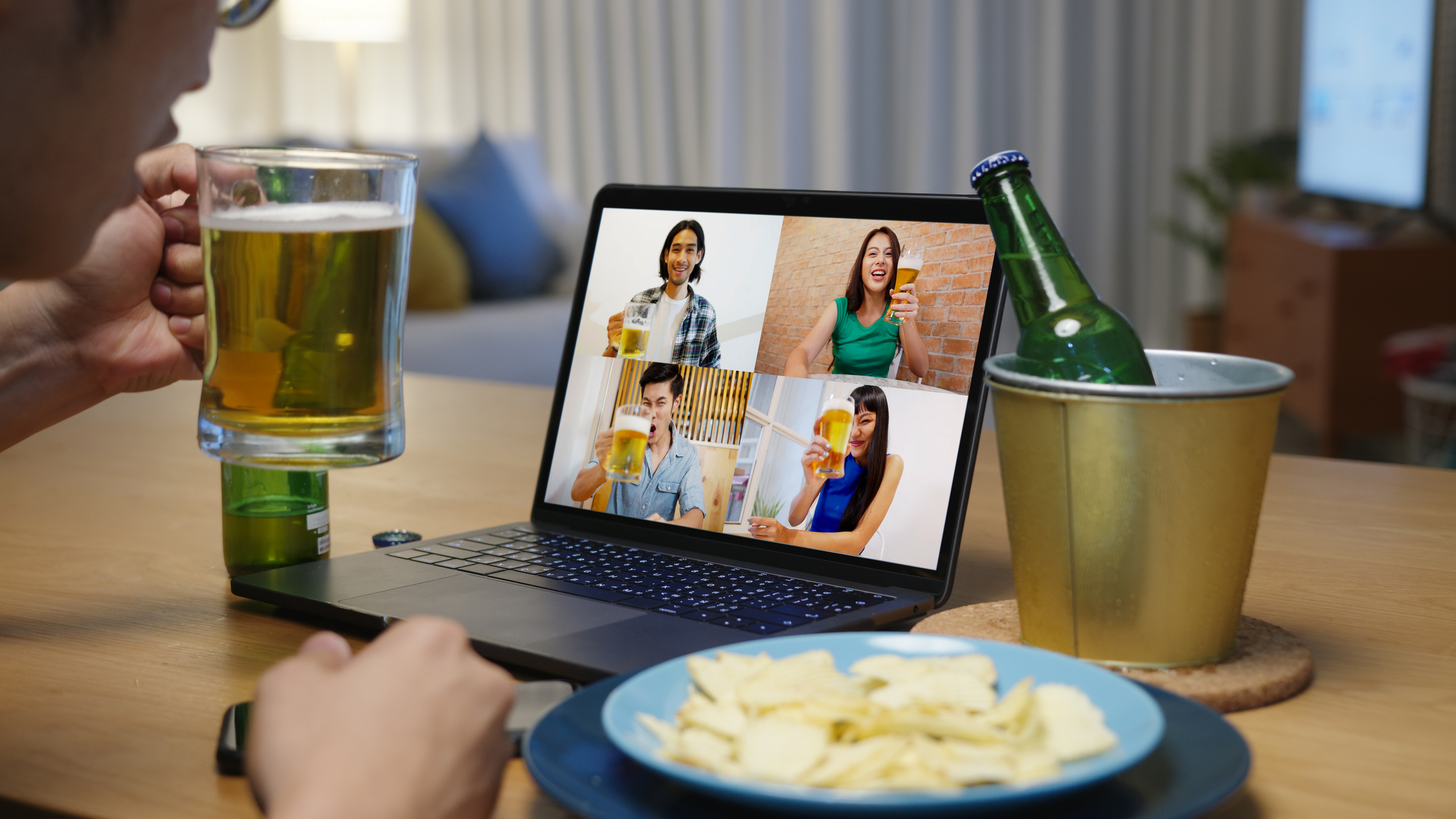 Young man joining virtual happy hour with friends